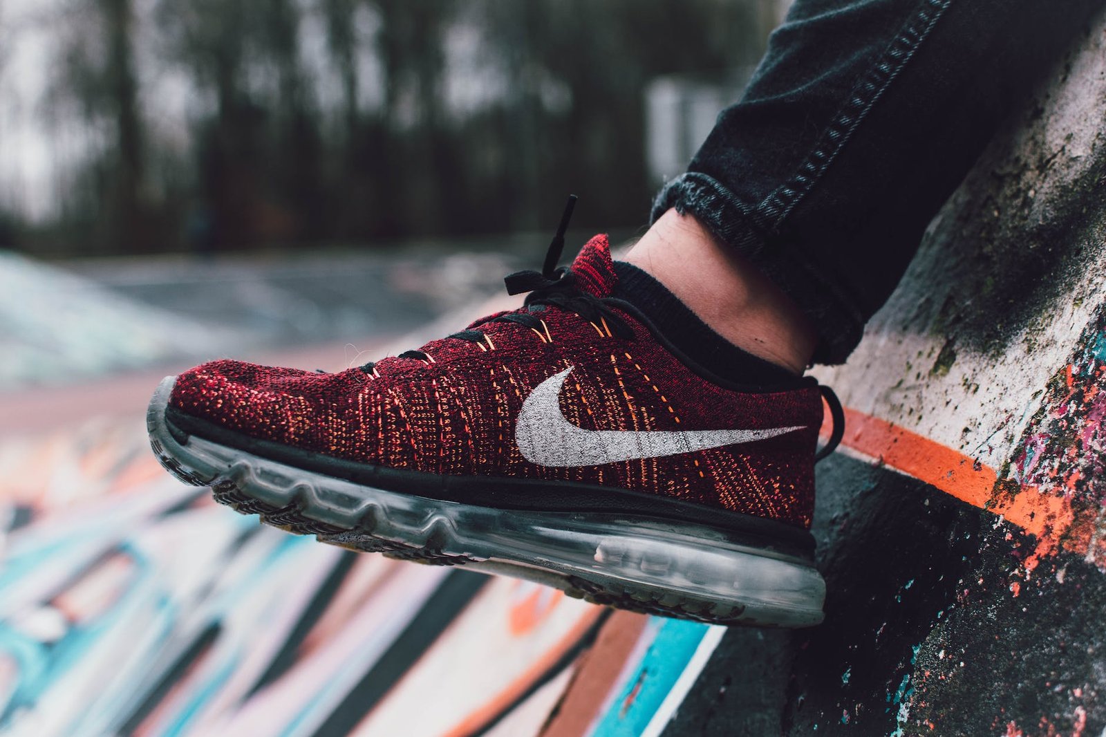 close up photography of red and black nike running shoe